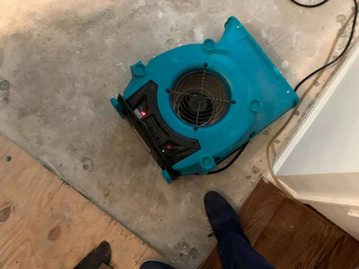 Air mover drying subfloor during Leak Detection & Repair in Fox Crossing